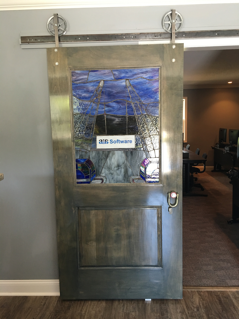 A1A Software commissioned an original stain glass from a local artist for the front door to the company’s new training center. The handle is made from a Crosby shackle.
